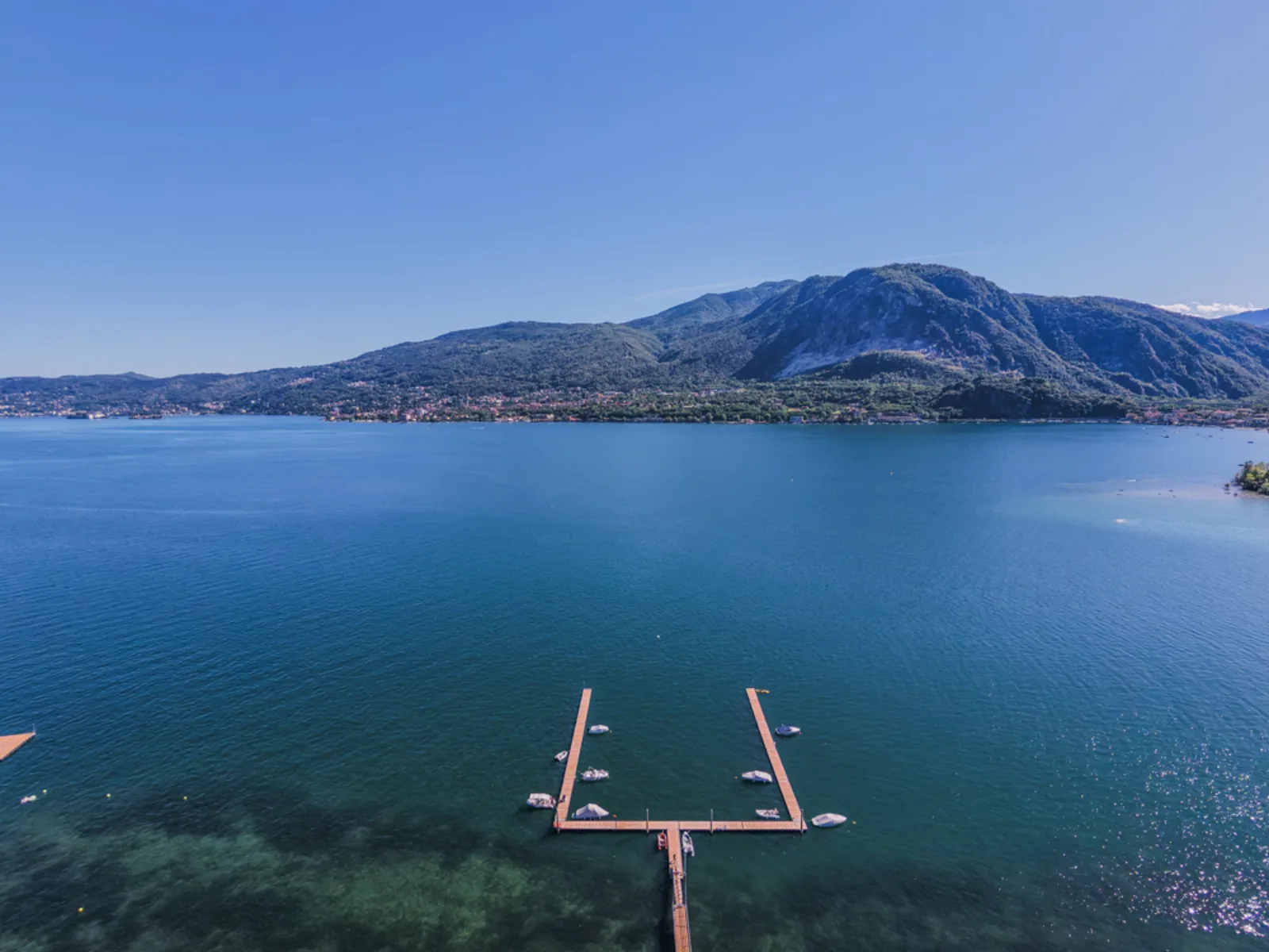 Pontoon reaching out into the clear blue water of Lake Maggiore
