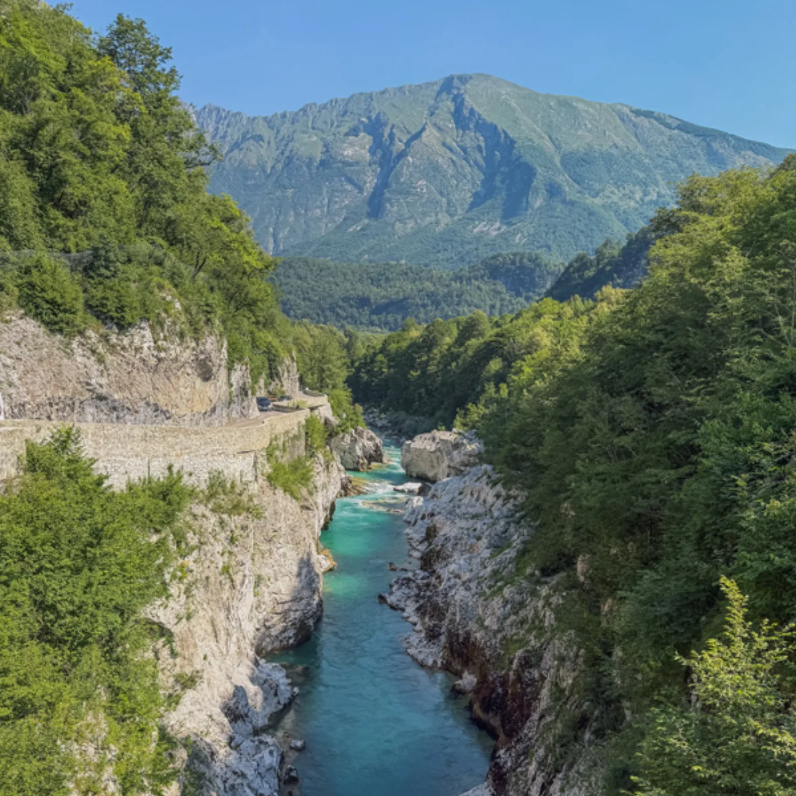 The turquoise Soča River running through a steep gorge below the mountains