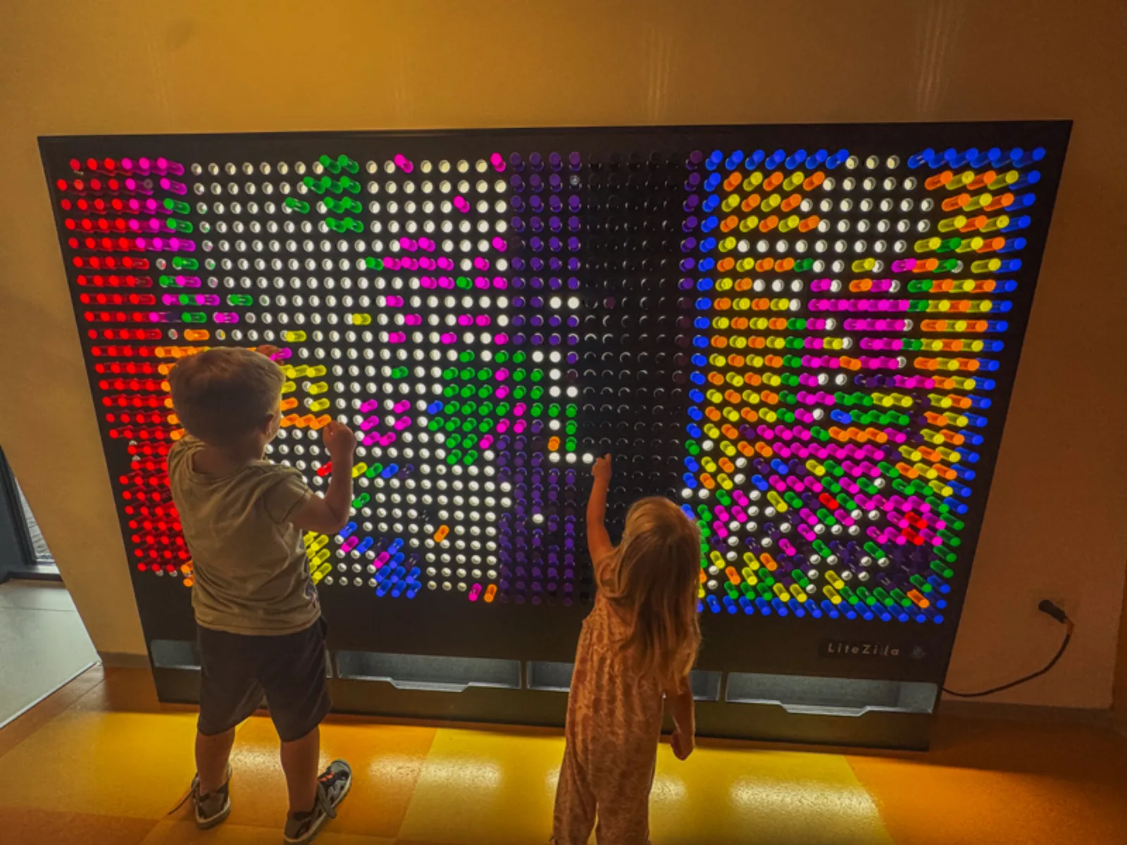 Children playing at a giant light box in the indoor entertainment area