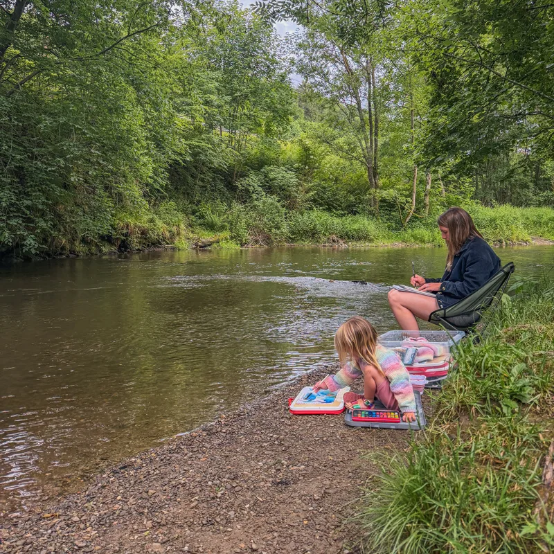 Sitting by the river at our campsite in the Belgian Ardennes