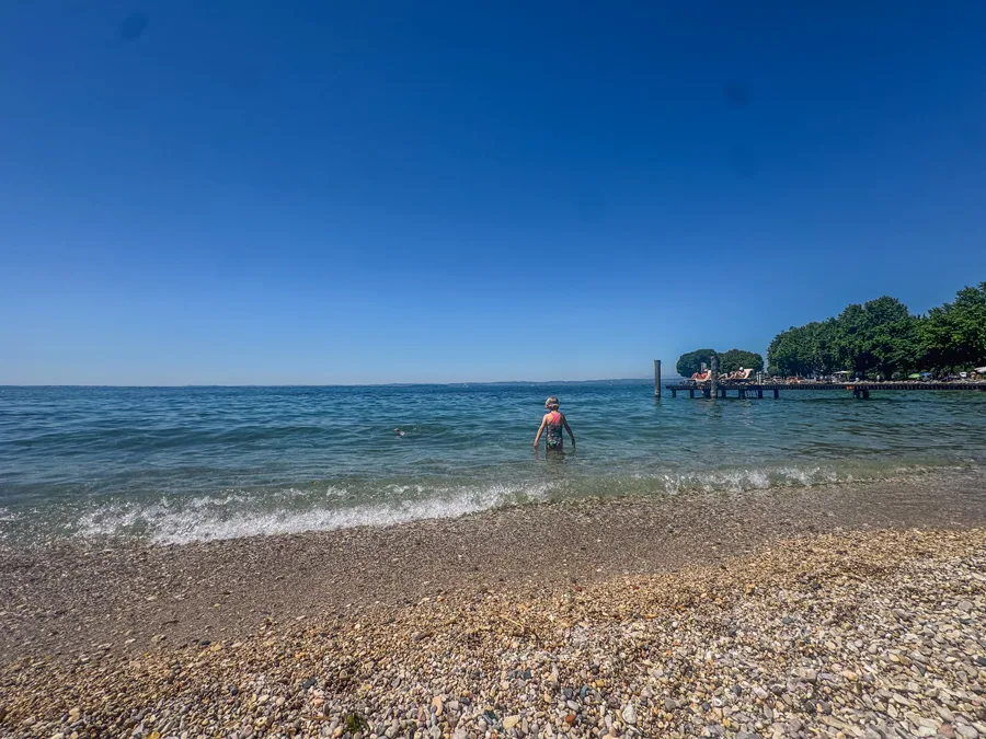 Wading into the clear water at Lake Garda near Bardolino